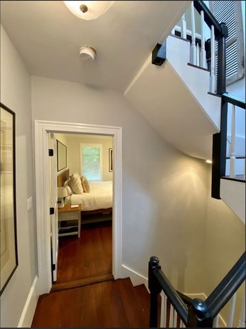 a view of a livingroom with furniture and hardwood floor