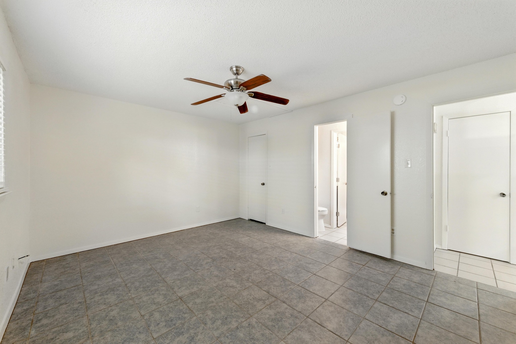 2002 Rabb Road Austin, TX 78704 - Photo 23 of 25 A second bedroom featuring tiled flooring and a practical ceiling fan.