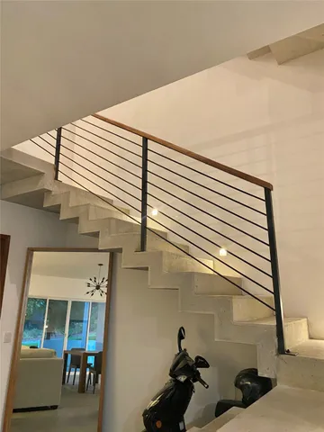 a large white bed in a bedroom next to a window and a lamp