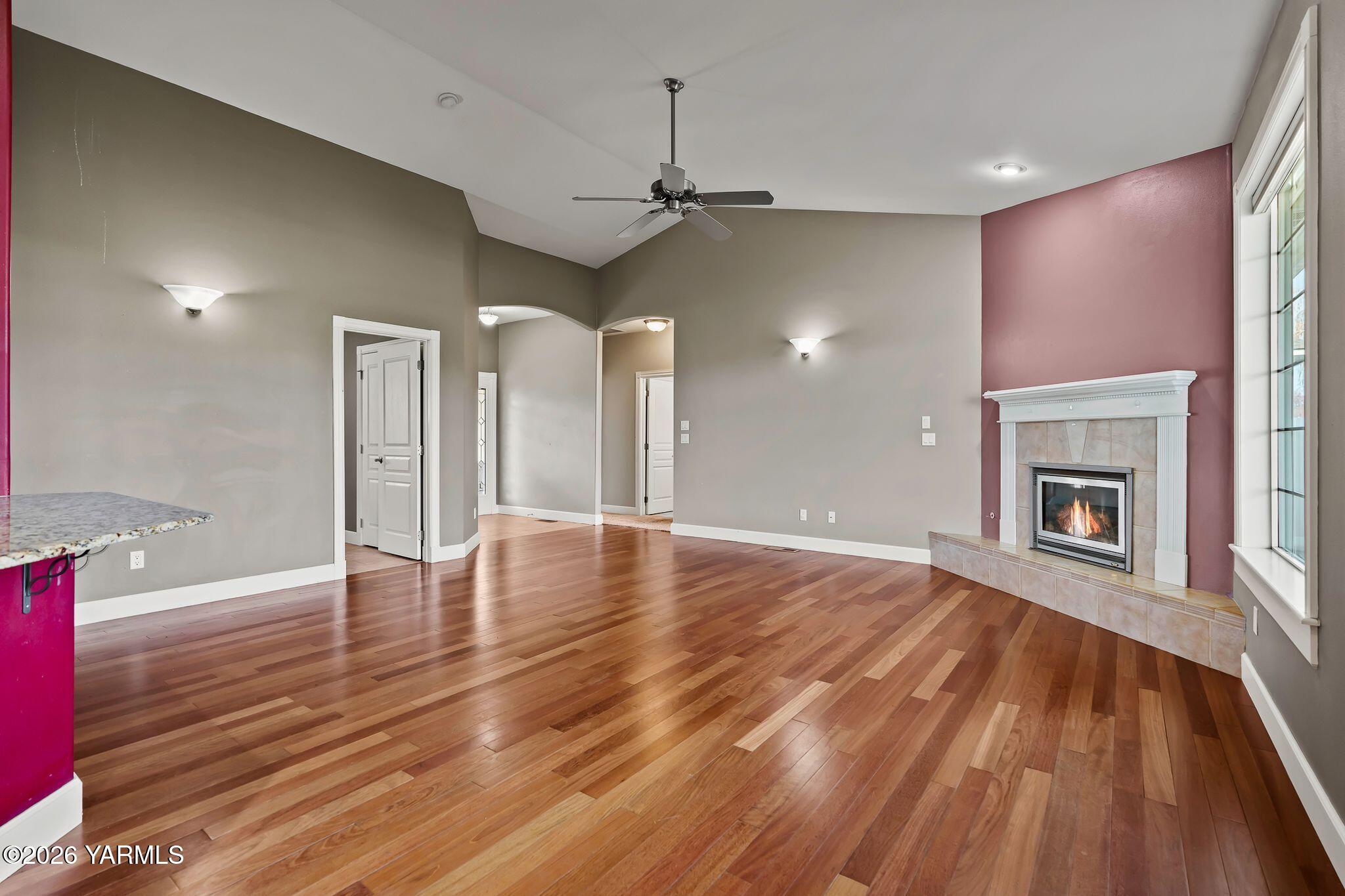 8507 Midvale Road Yakima, WA 98908 - Photo 6 of 24 a view of an empty room with wooden floor fireplace and a window
