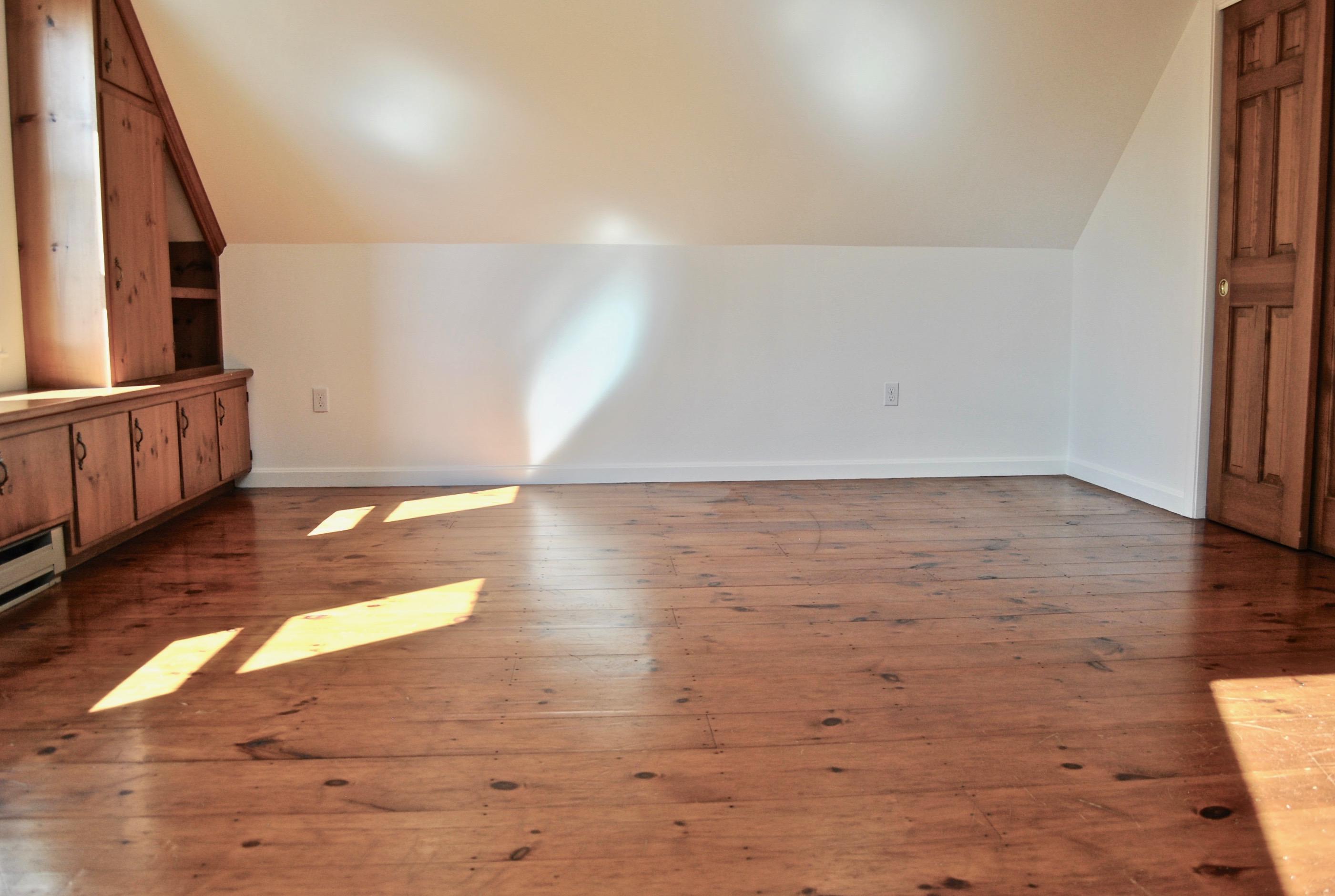 46 Partridge Path Chatham, MA 02633 - Photo 25 of 42 a view of an empty room with wooden floor and a window