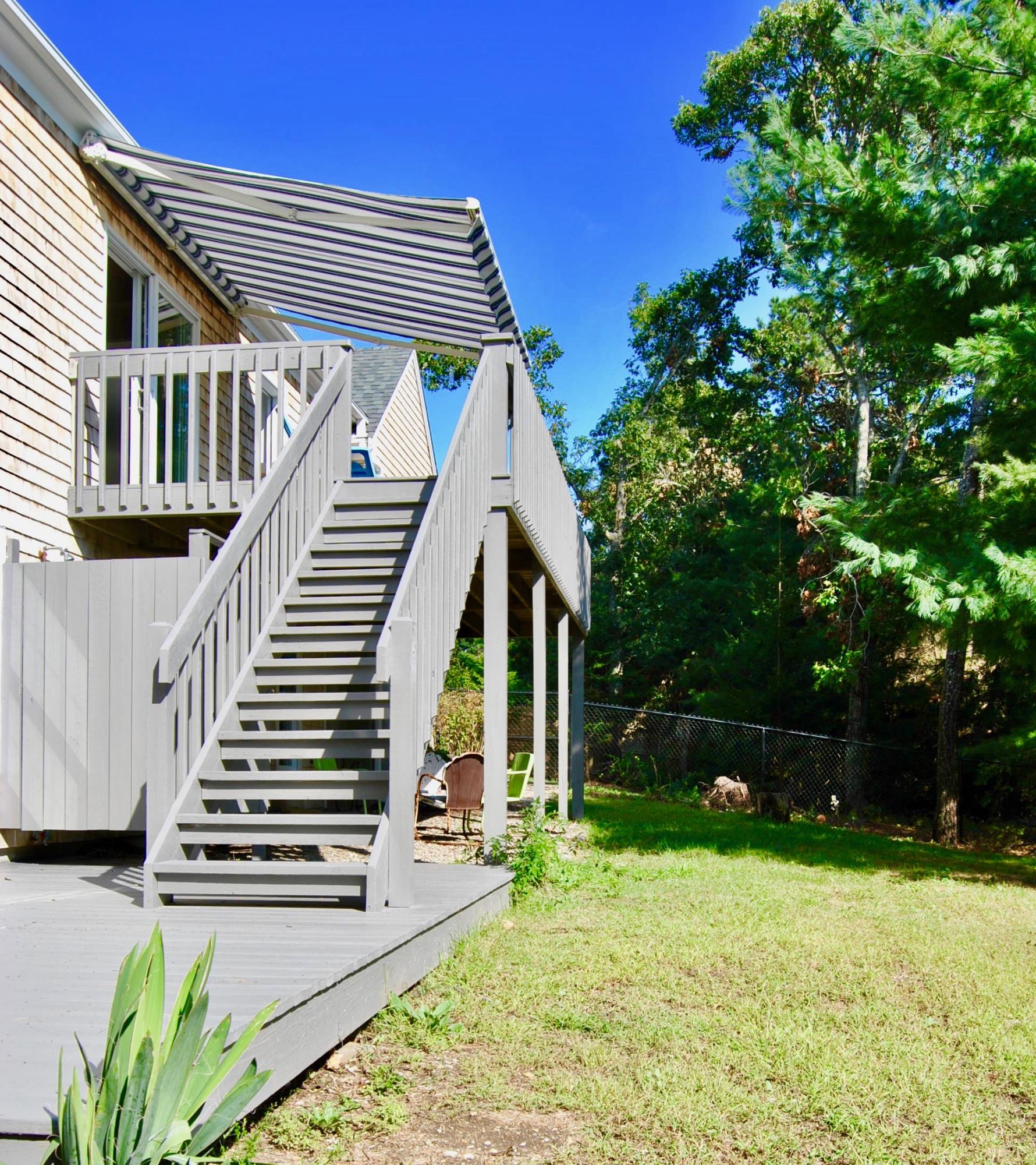 46 Partridge Path Chatham, MA 02633 - Photo 39 of 42 a backyard of a house with wooden floor and trees
