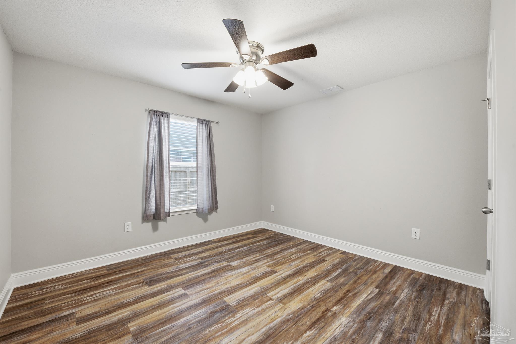 5661 Cane Syrup Circle Pace, FL 32571 - Photo 17 of 20 wooden floor in an empty room with a window