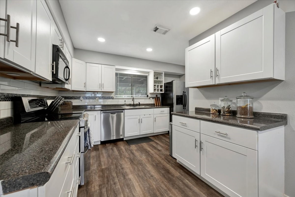 2610 Loganberry Circle Seabrook, TX 77586 - Photo 13 of 35 a kitchen with granite countertop stainless steel appliances and white cabinets