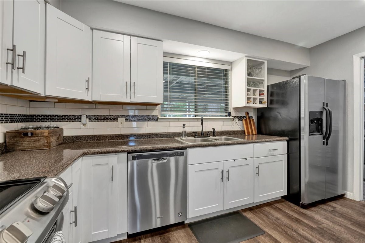 2610 Loganberry Circle Seabrook, TX 77586 - Photo 15 of 35 a kitchen with stainless steel appliances granite countertop a sink stove and refrigerator