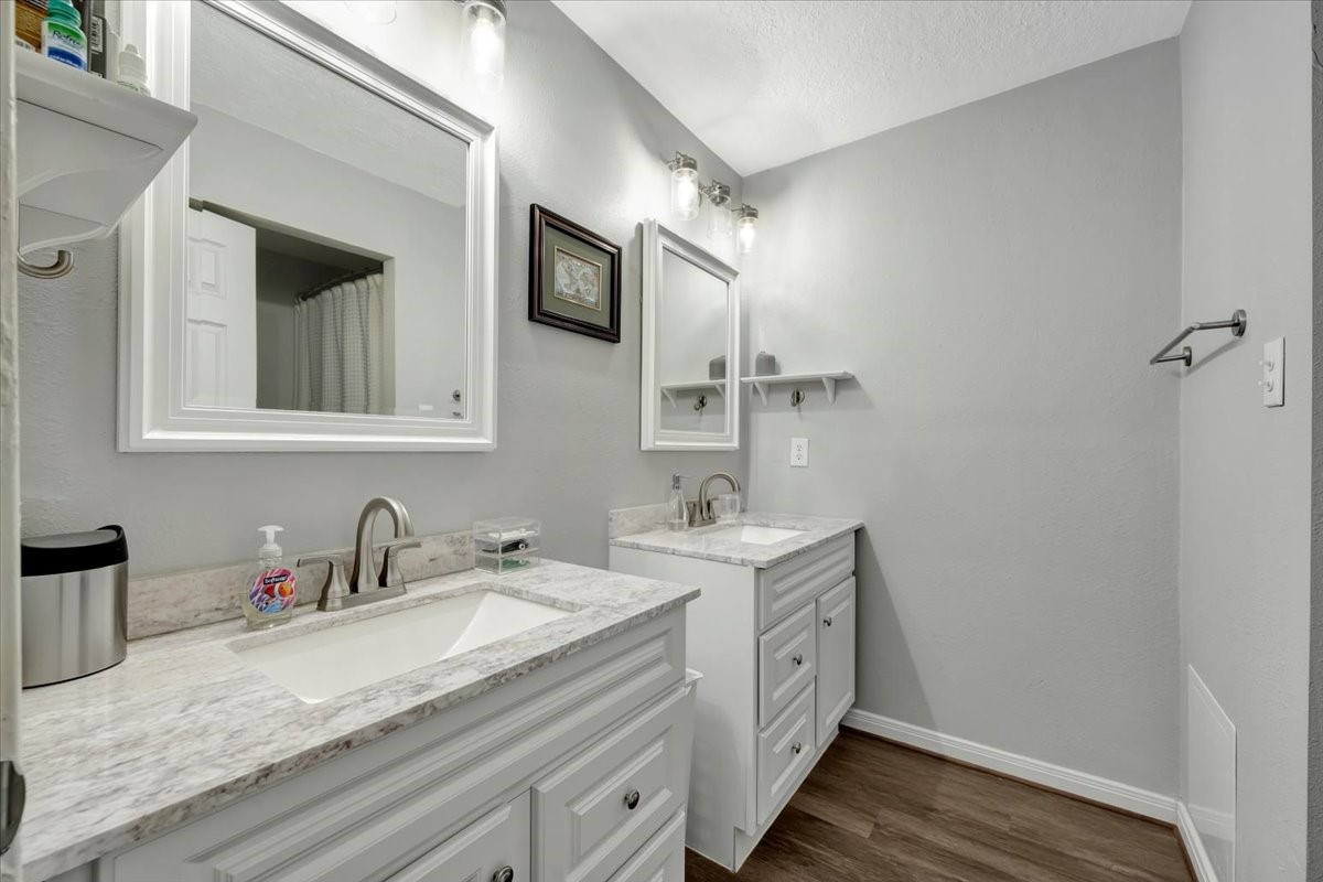 2610 Loganberry Circle Seabrook, TX 77586 - Photo 26 of 35 a bathroom with a granite countertop sink mirror and vanity