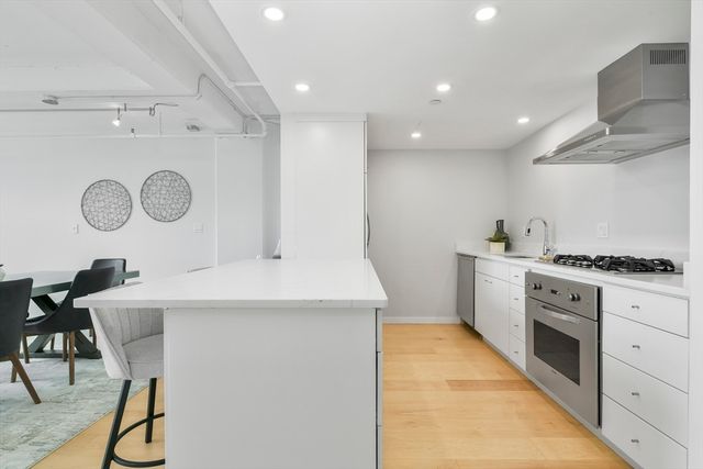 a kitchen with cabinets and stove