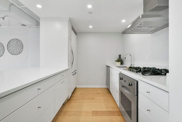 a living room with furniture kitchen view and a table