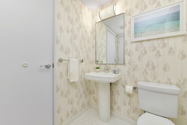 a view of staircase with railing and white walls