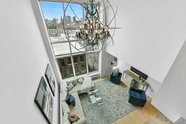 a bedroom with a large bed and wooden floor