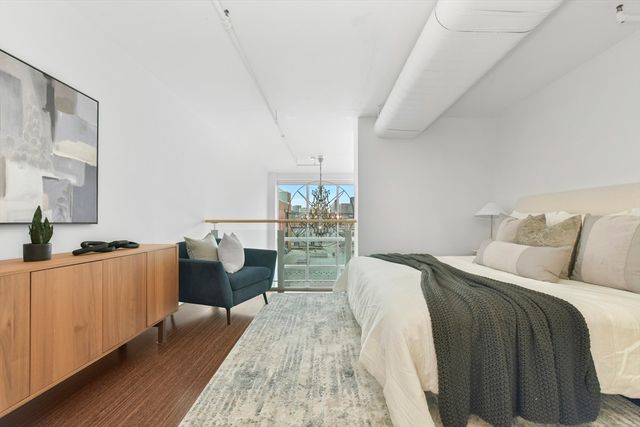 a bedroom with furniture and wooden floor