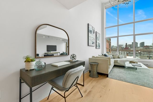 a room with a couch and a view of living room