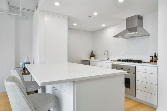 a kitchen with a white table chairs and a refrigerator