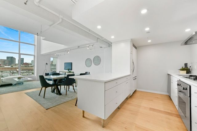 a kitchen with a sink a stove and chairs