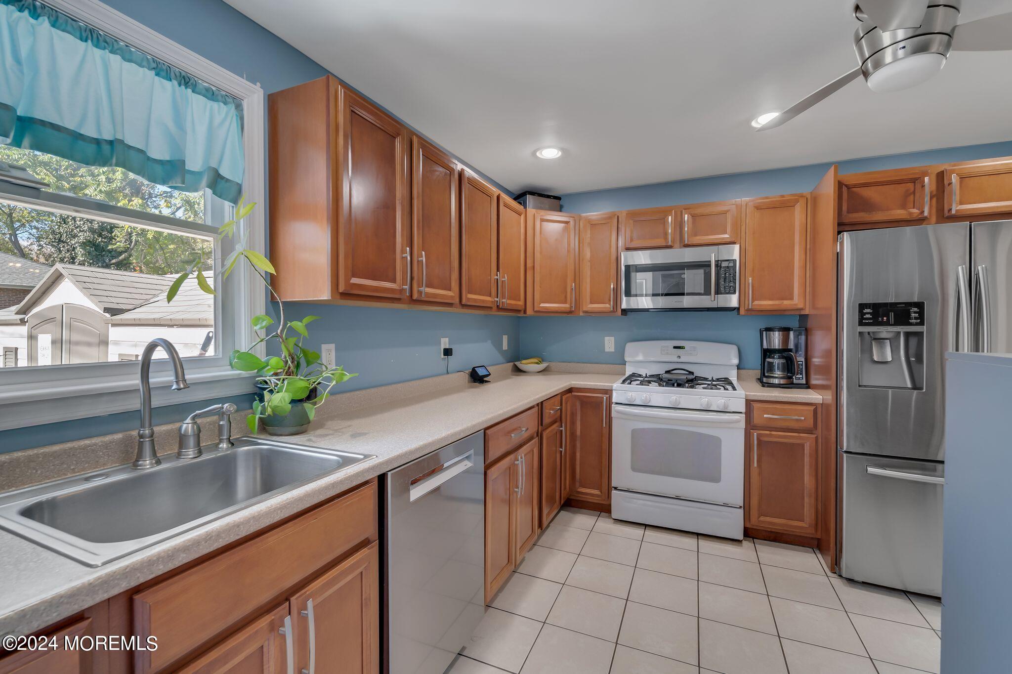 238 Branchport Avenue Long Branch, NJ 07740 - Photo 14 of 42 a kitchen with a sink stove and refrigerator