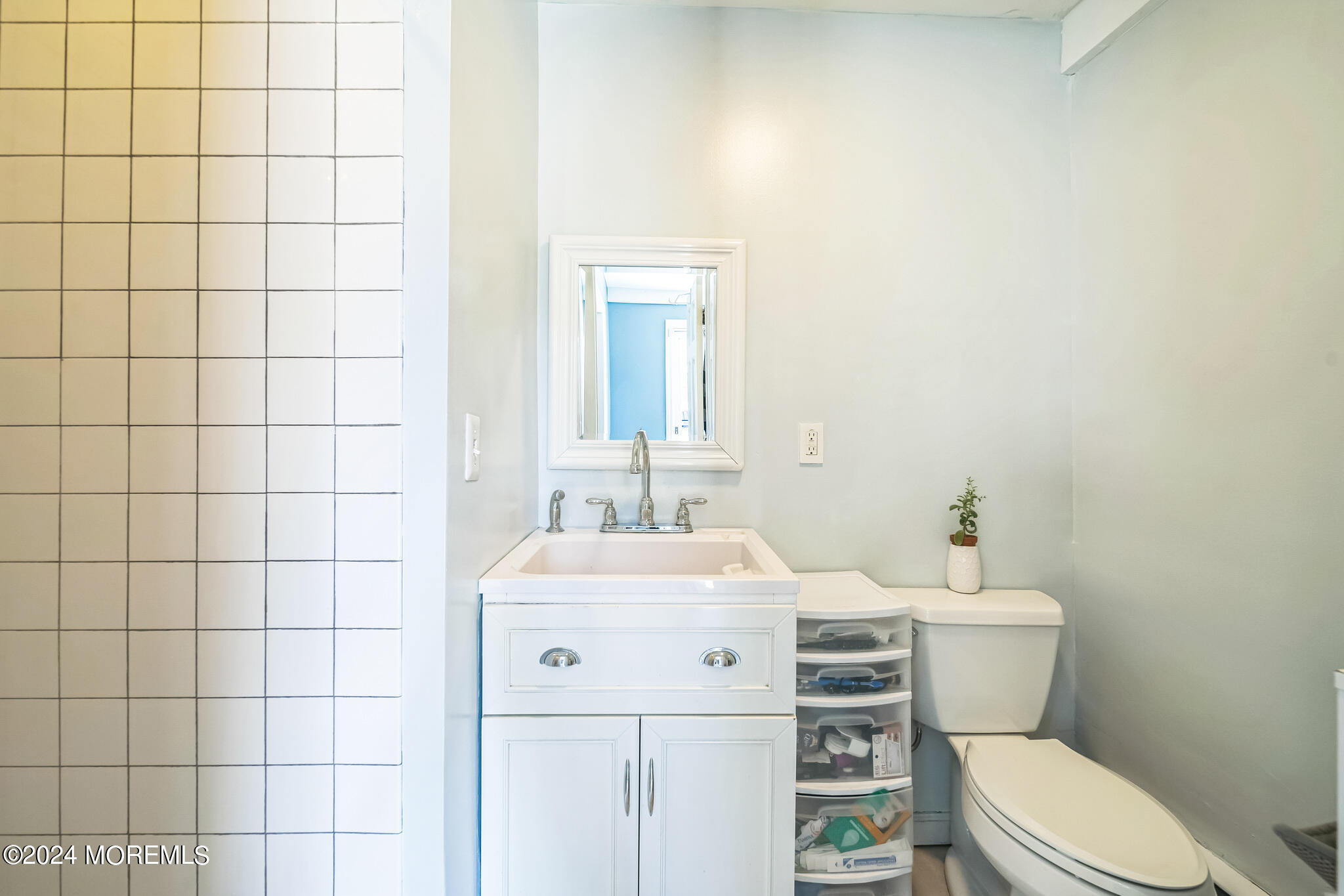 238 Branchport Avenue Long Branch, NJ 07740 - Photo 16 of 42 a bathroom with a sink a toilet and mirror