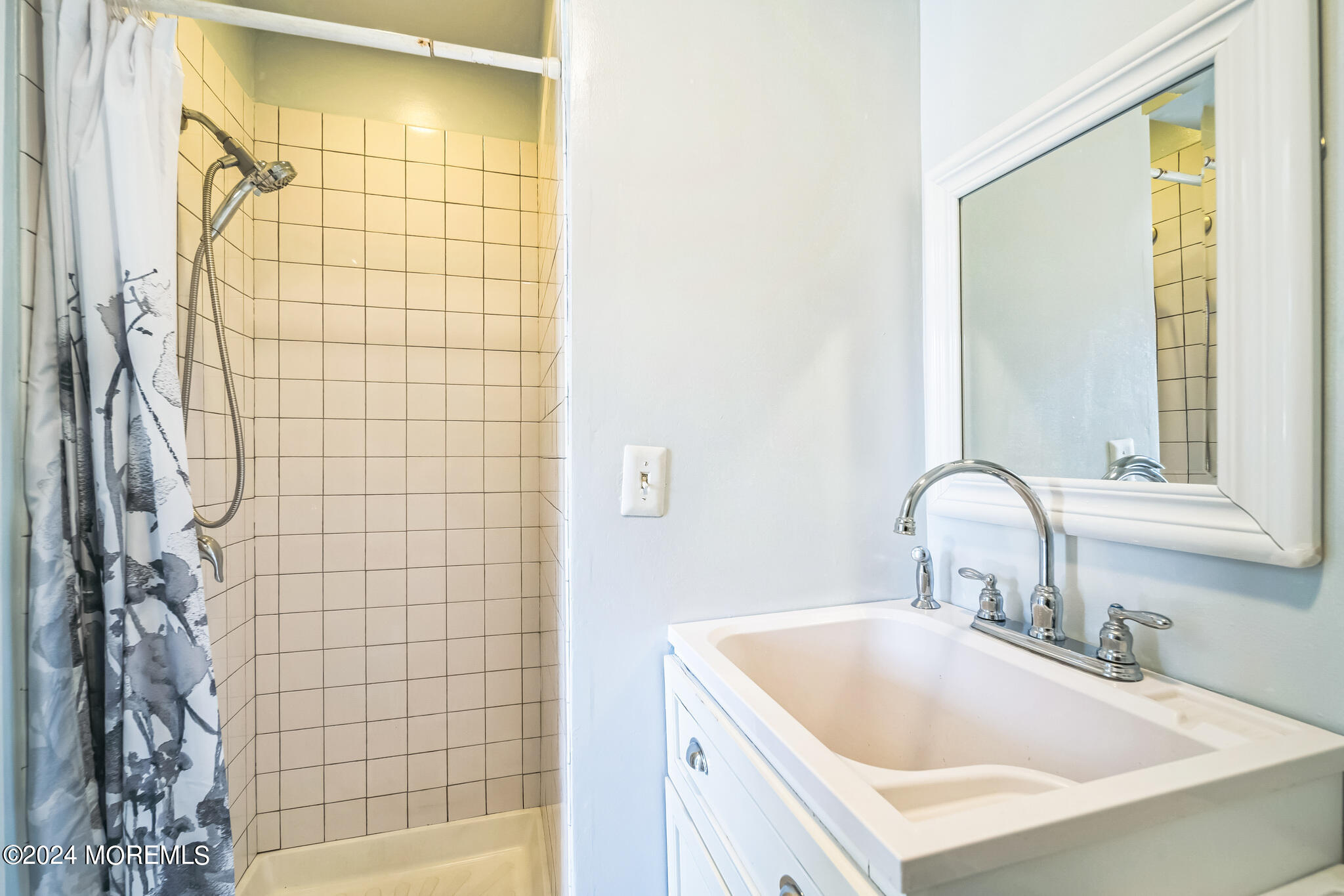 238 Branchport Avenue Long Branch, NJ 07740 - Photo 17 of 42 a bathroom with a sink a shower and a bathtub