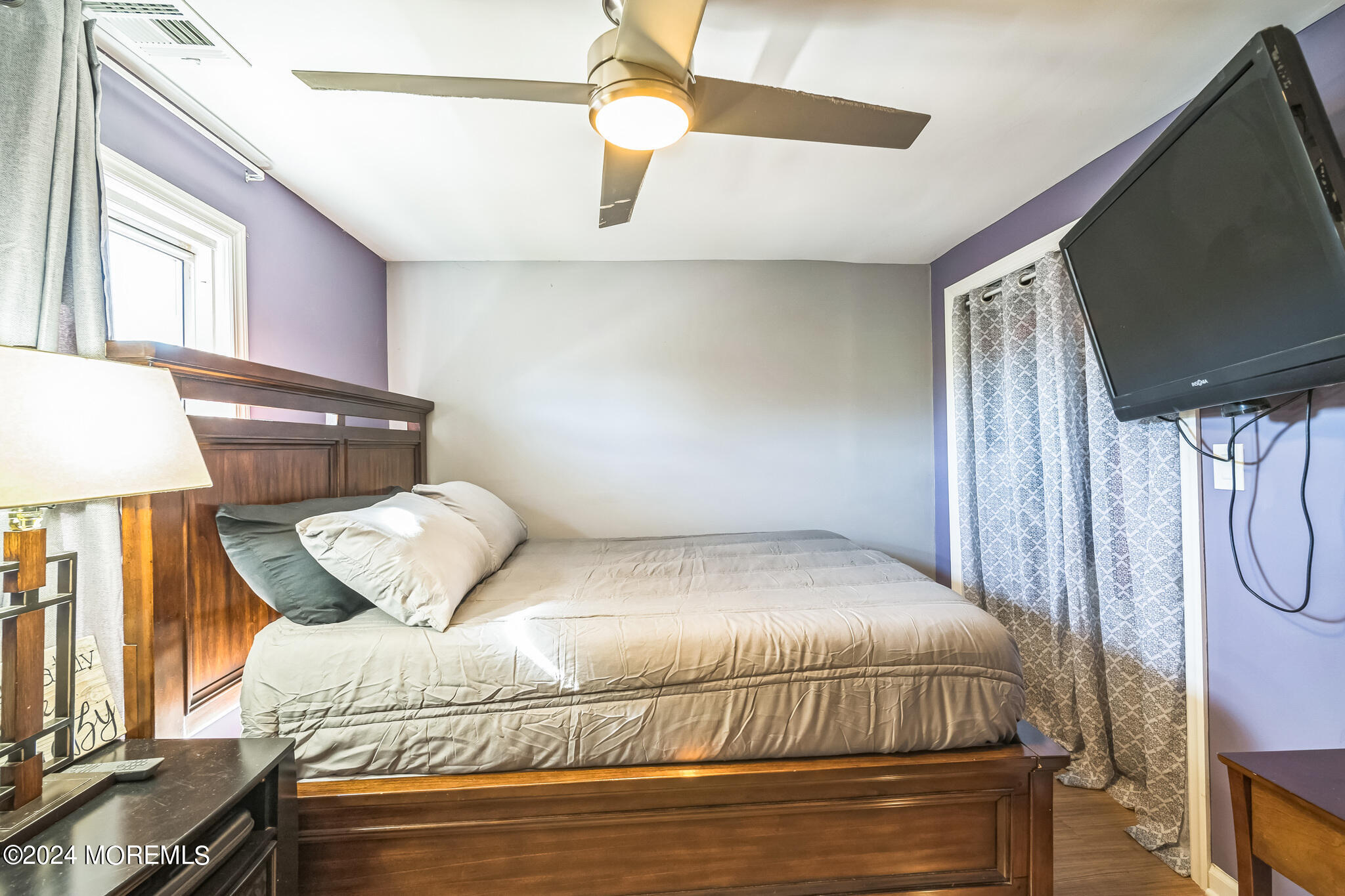 238 Branchport Avenue Long Branch, NJ 07740 - Photo 21 of 42 a bedroom with a bed and a flat screen tv