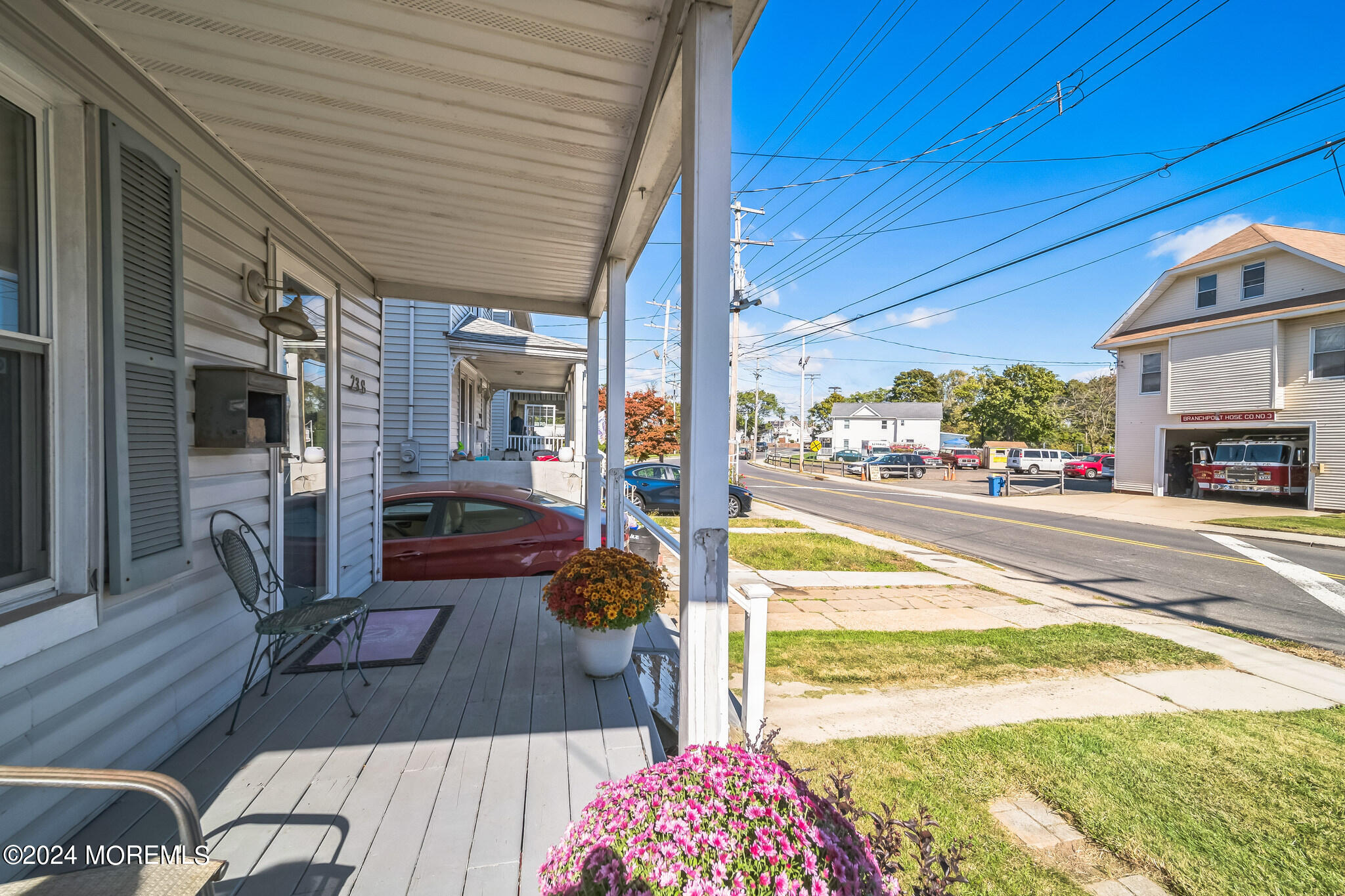 238 Branchport Avenue Long Branch, NJ 07740 - Photo 4 of 42 a view of a patio with table and chairs potted plants with wooden floor