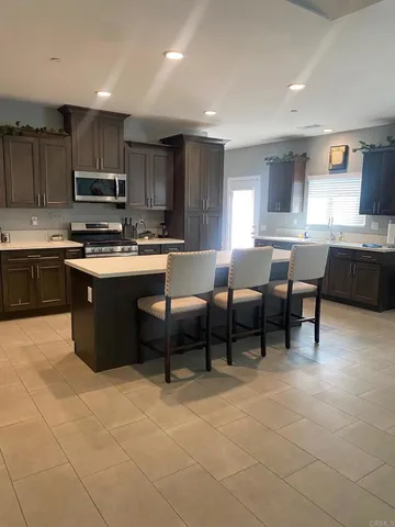 a open kitchen with cabinets table and chairs