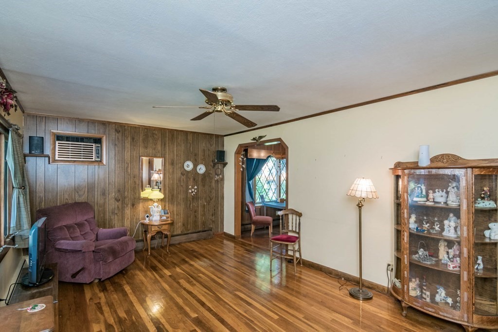 401 Stapleton Road Springfield, MA 01109 - Photo 5 of 35 a living room with furniture a chandelier and wooden floor