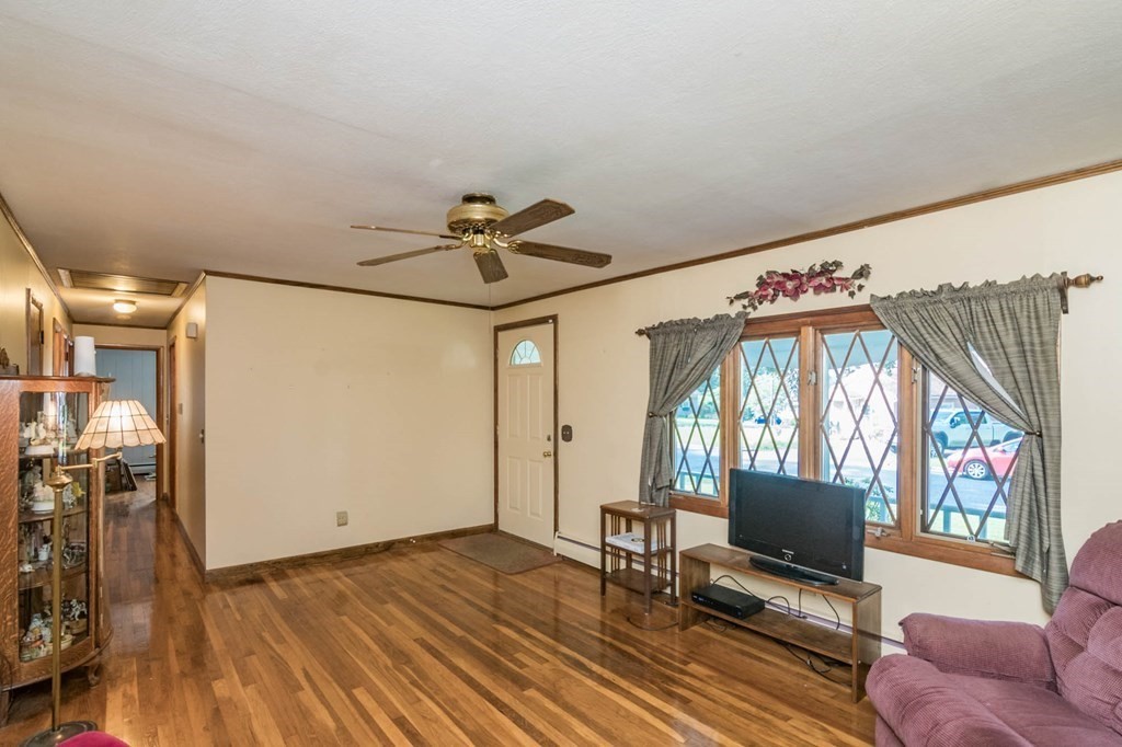 401 Stapleton Road Springfield, MA 01109 - Photo 6 of 35 a view of livingroom with furniture wooden floor windows and a flat screen tv