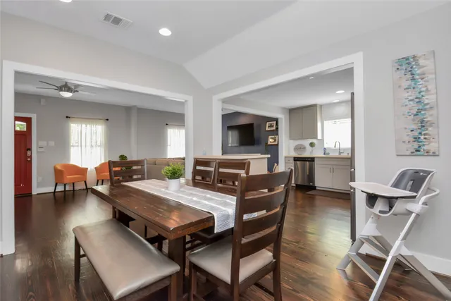 a living room with furniture a dining table and chairs