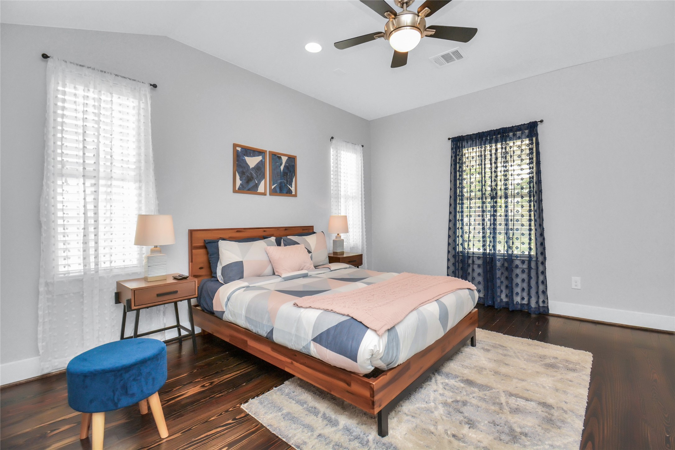 5705 Cochran Street Houston, TX 77009 - Photo 15 of 34 a bedroom with a bed a window and a chandelier