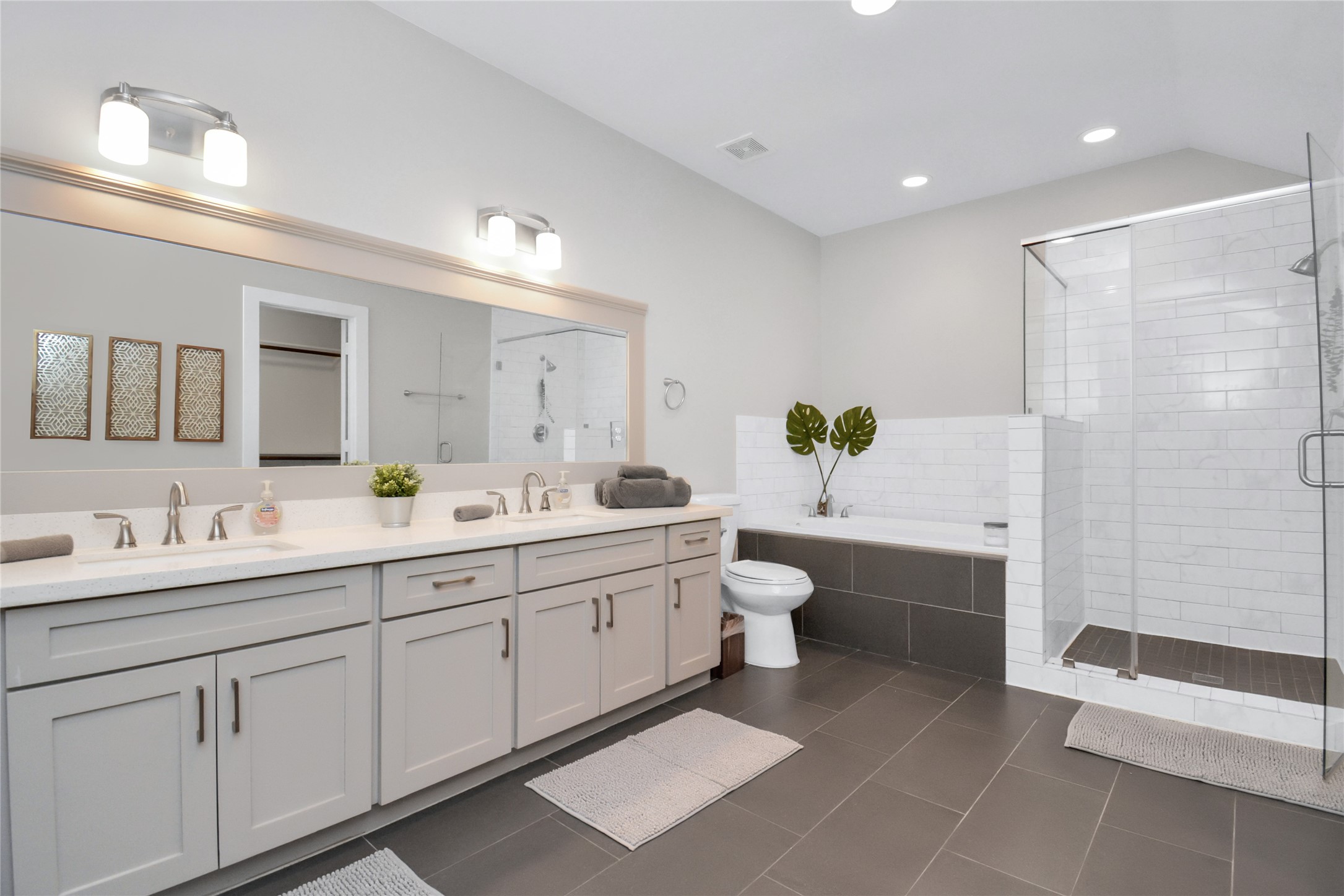 5705 Cochran Street Houston, TX 77009 - Photo 16 of 34 a spacious bathroom with a double vanity sink toilet and shower