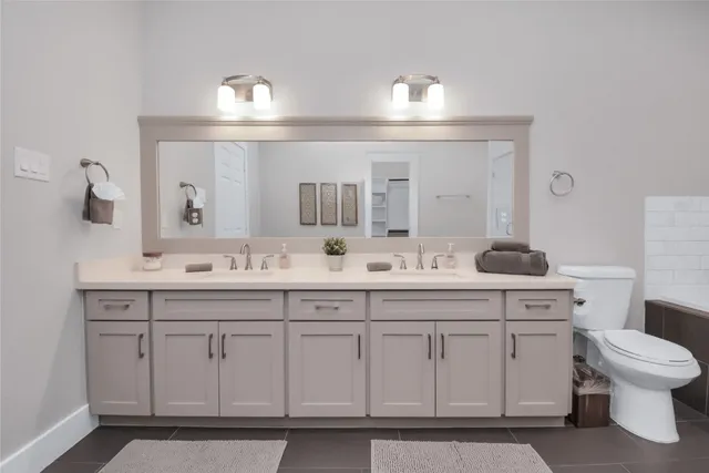 a bathroom with a sink vanity and a mirror