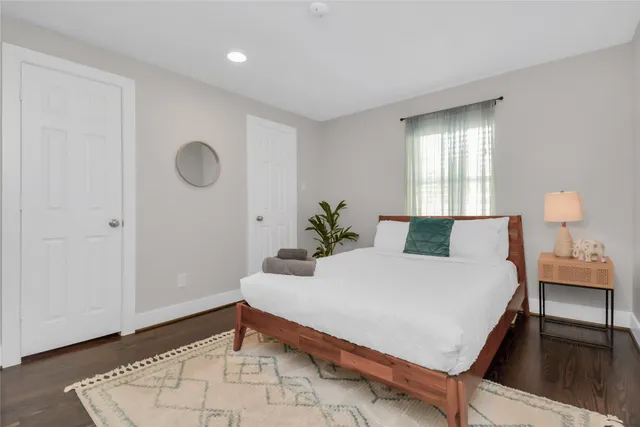 a bedroom with a bed and a potted plant