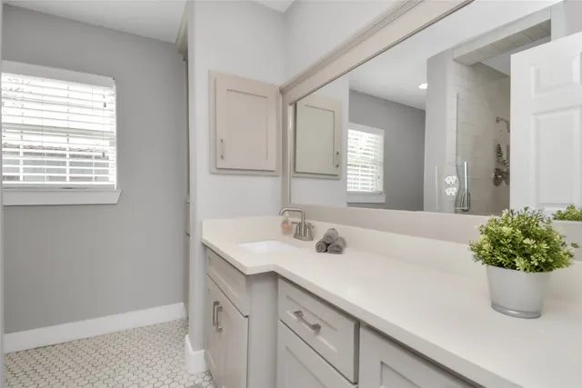 a bathroom with a sink a vanity and a mirror