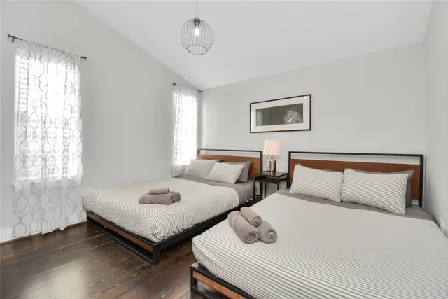 a bedroom with beds and a window