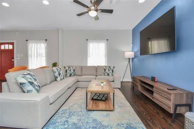 a living room with furniture and a flat screen tv