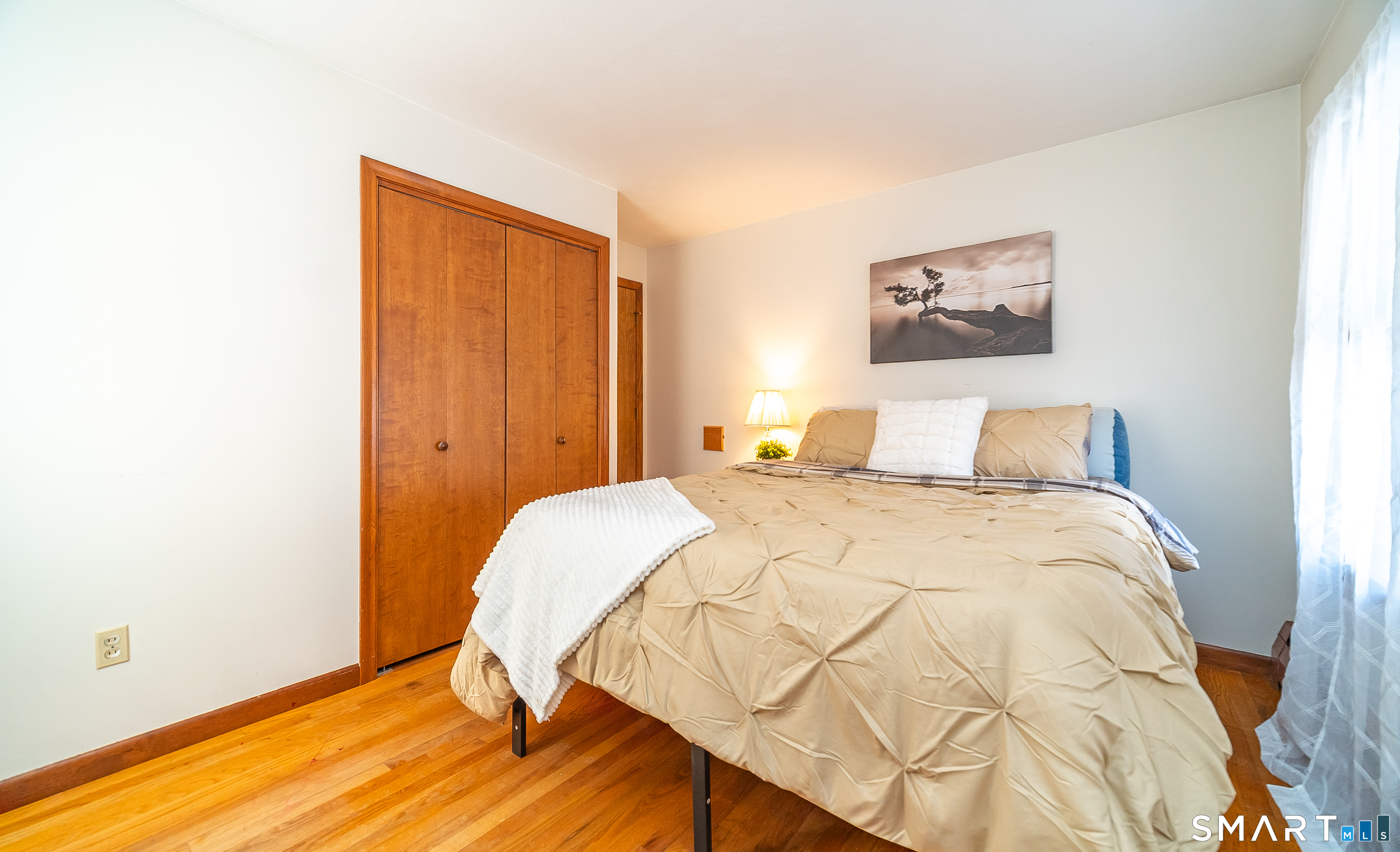 20 Prospect Street Middletown, CT 06457 - Photo 17 of 30 a bedroom with a bed and a painting on the wall