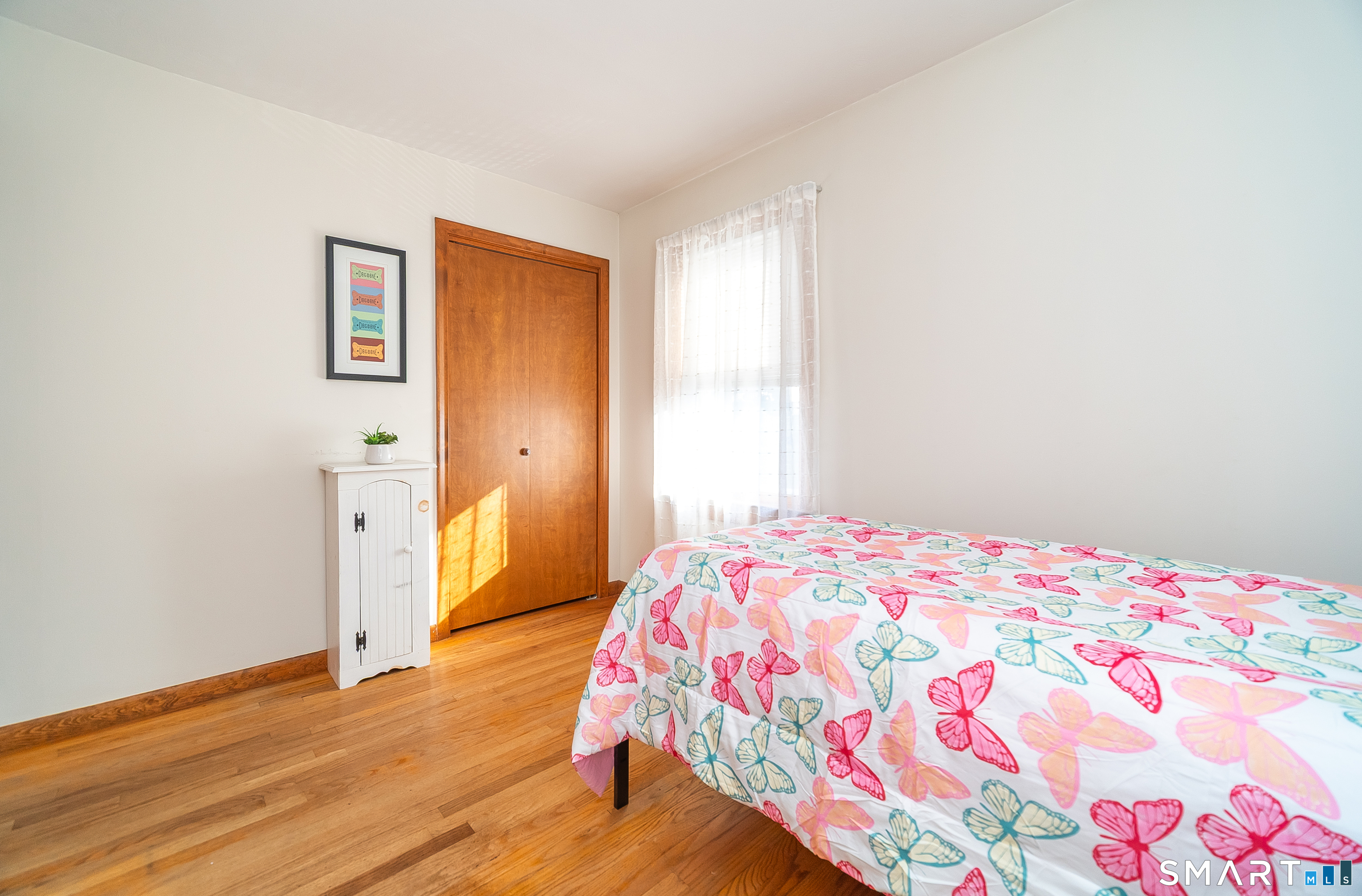 20 Prospect Street Middletown, CT 06457 - Photo 19 of 30 a bedroom with a bed and wooden floor