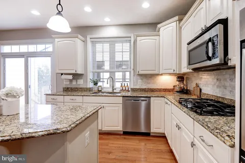 a kitchen with stainless steel appliances a stove and cabinets