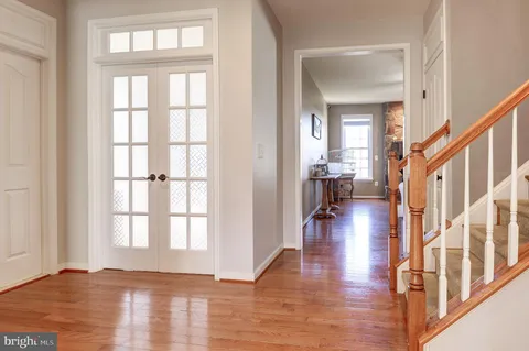 a spacious bedroom with a bed and a flat screen tv