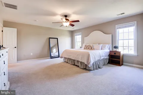 a spacious bathroom with a tub sink and mirror