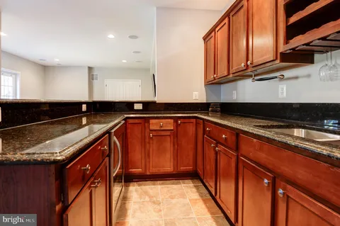 a living room with furniture a flat screen tv and a book shelf