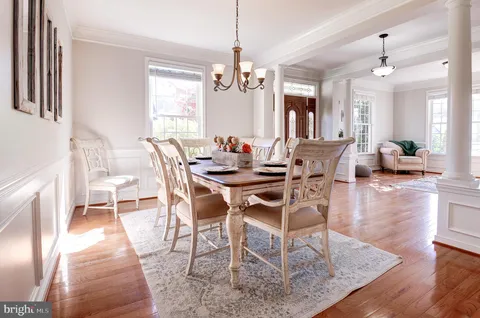 a view of a dining room with furniture wooden floor and chandelier