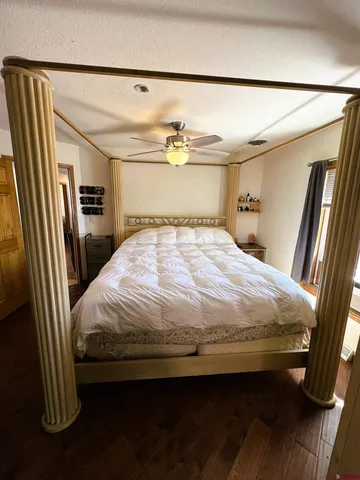 a bedroom with a bed and a mirror