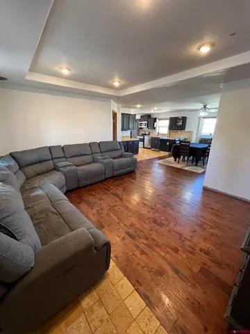 a living room with furniture and a wooden floor