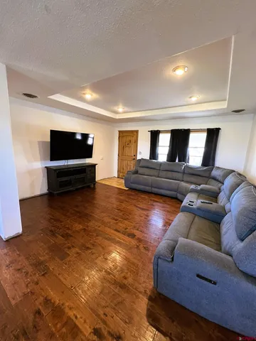 a living room with furniture and a wooden floor