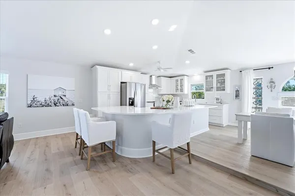 a kitchen with white cabinets and refrigerator