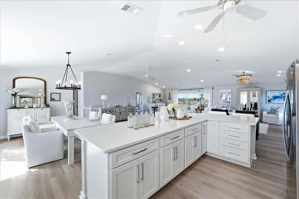 a kitchen with a sink cabinets and a window