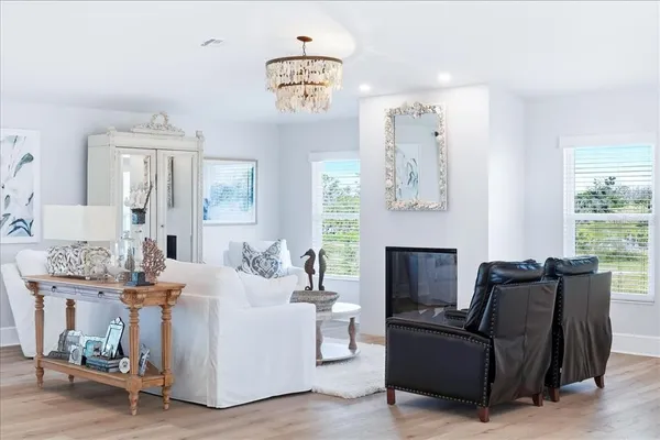 a living room with kitchen island furniture and a chandelier