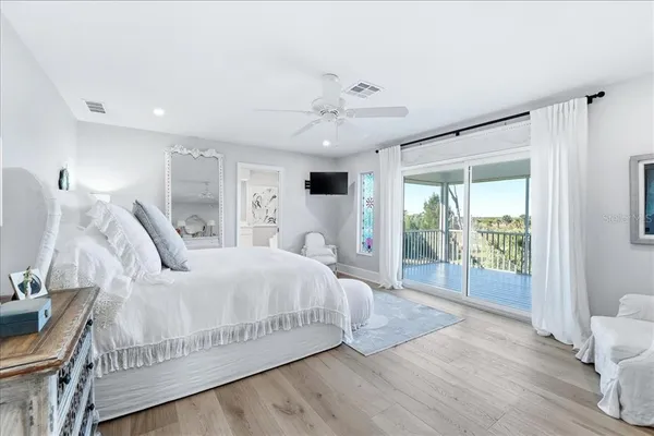 a spacious bedroom with a bed and window