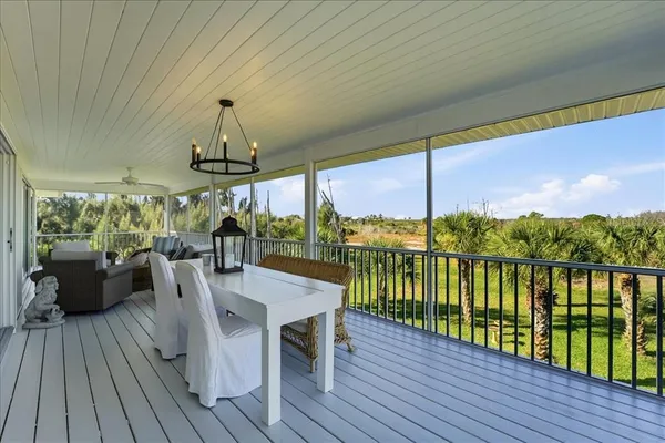 a balcony with furniture and wooden floor