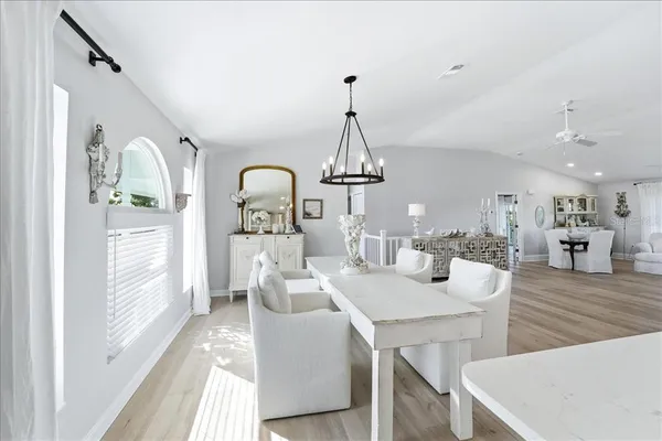 a living room with stainless steel appliances kitchen island furniture and wooden floor